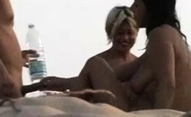 Blonde And Brunette Amateur Milfs Share A Cock On The Beach